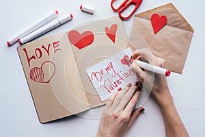 Hands write valentine