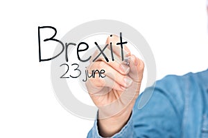 Hands writing brexit