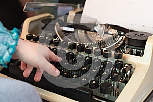 Hands writing on an old typewriter. retro-style. keyboard and font