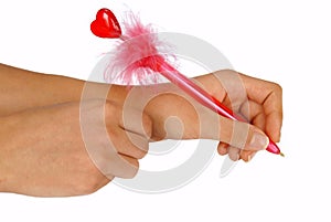 Hands writing on white paper