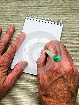 Hands writing the word can't