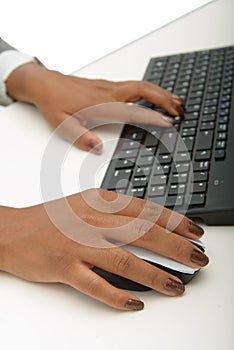 Hands of a young african woman using a computer