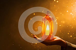 Hands of young asian muslim man hold shiny arabic lantern, with glitter and sparkle effect