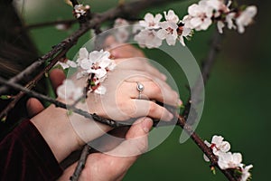 Hands of a young couple with a ring. close up of man giving diamond ring to woman