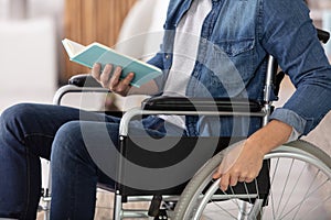 hands young disable man holding book