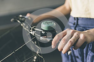 Hands of a young girl on old vintage bicycle handlebar