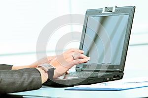 Hands of a young girl working on laptop