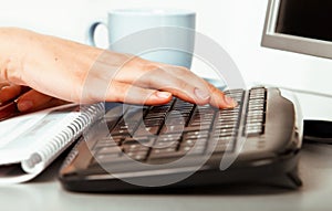 Hands of a young girl working on laptop