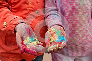 Hands of young people with Indian dyes on Holi color festival