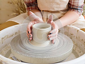 Hands of young potter, was produced on range of pot