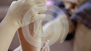 Hands of young woman gently touch massage to foot leg and ankle of old women metaphor and concept for body health care and therapy