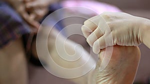 Hands of young woman gently touch massage to foot shin and leg of old women metaphor and concept for body health care