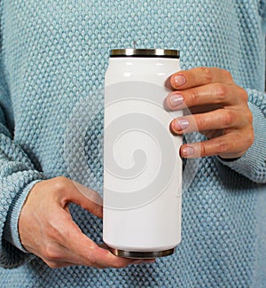 Hands of a young woman holding a Cup of coffee or tea.