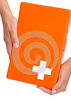 Hands of young woman holding first aid kit