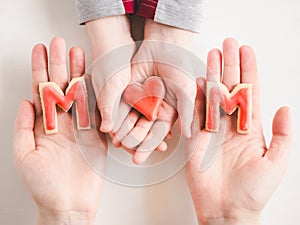 Hands of a younger daughter and her mother`s