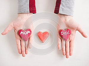 Hands of a younger daughter and word MOM