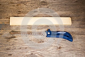 Handsaw over a wooden boards