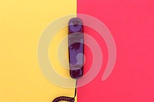 The handset lies on yellow and red colors.