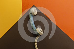 Handset of old retro phone isolated on colorful background