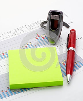 Handsfree, notes and pen on earnings chart background