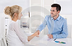 Handshake: Adviser says hello to his female customer. photo