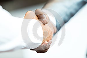 Handshake between african and a caucasian man