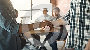 Handshake between african and caucasian man at meeting