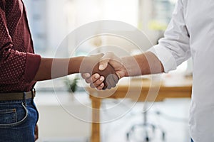 Handshake, agreement and meeting of business people in the office after a good deal. Closeup of diverse corporate