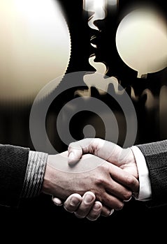 Handshake with black gears background