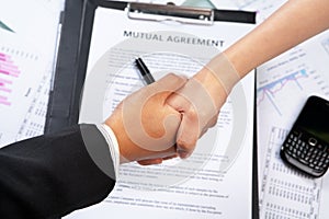 Handshake btween businesswoman over agreement