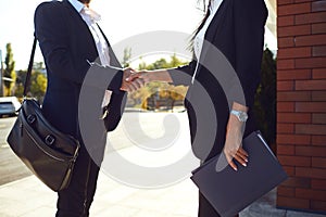 Handshake business. Businessman and business woman make handshakes while standing outdoors