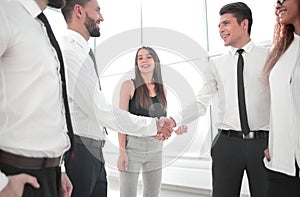 Handshake between business colleagues in the office