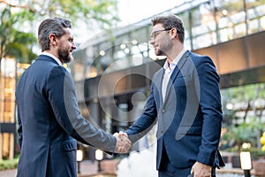 Handshake with business partner in the city for greeting. Handshake between two business men. Two businessmen shaking