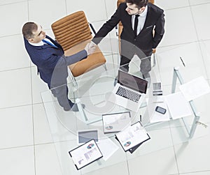 Handshake business partners before considering a new financial agreement