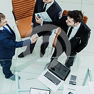 Handshake business partners before considering a new financial agreement