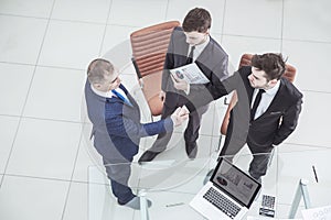 Handshake business partners before considering a new financial agreement