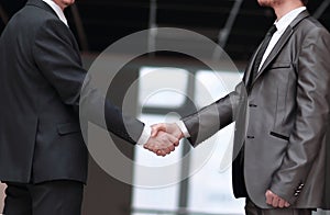 Handshake of business partners in the corridor of the office