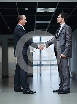 Handshake of business partners in the corridor of the office