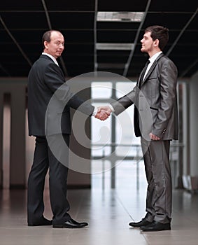 Handshake of business partners in the corridor of the office