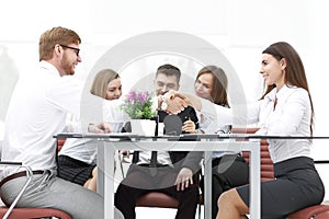 Handshake of business partners on a Desk in the office