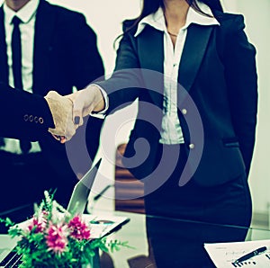 Handshake business partners after discussion of the contract at