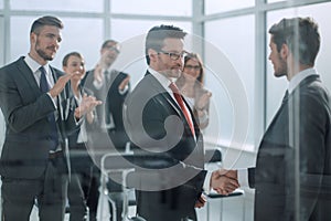 Handshake business partners at the meeting in the conference room