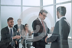 Handshake business partners at the meeting in the conference room