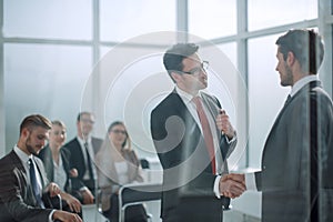 Handshake business partners at the meeting in the conference room