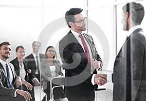 Handshake business partners at the meeting in the conference room