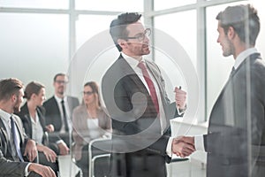 Handshake business partners at the meeting in the conference room