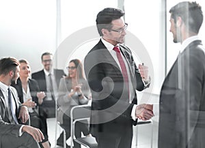 Handshake business partners at the meeting in the conference room