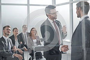 handshake business partners at the meeting in the conference room