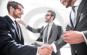 Handshake business partners in a modern office