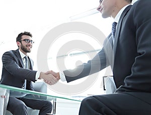 Handshake business partners in the office